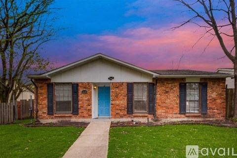 A house with a blue door and a white fence.