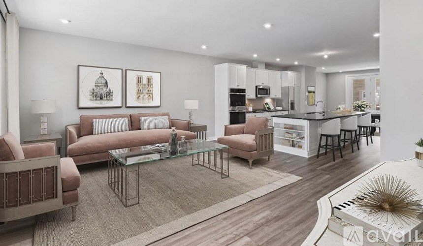 A modern living room with a kitchen in the background.