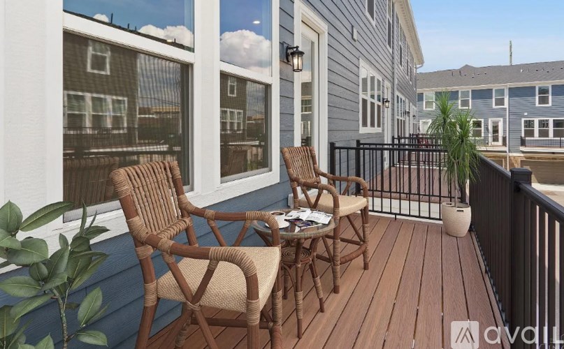 A balcony with two chairs and a table.