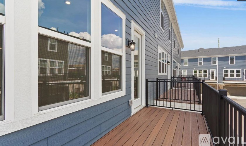 A balcony with a wooden floor and a metal railing.