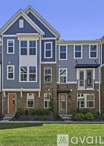A row of houses with the front door of the first house on the left.