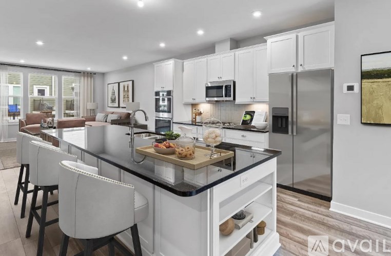 A modern kitchen with a large island and stainless steel appliances.