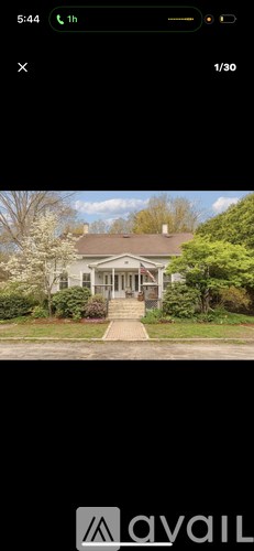 A house with a front yard and a driveway.