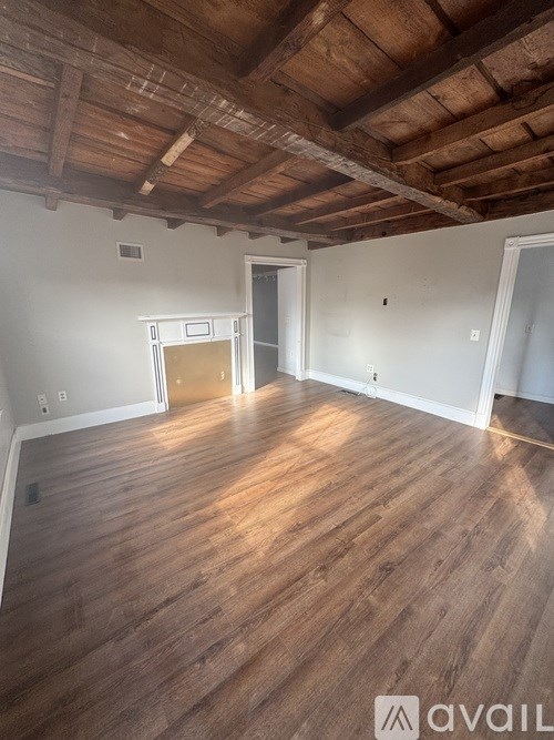 A room with wooden floors and a wooden ceiling.