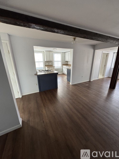 A room with wooden floors and a large window.
