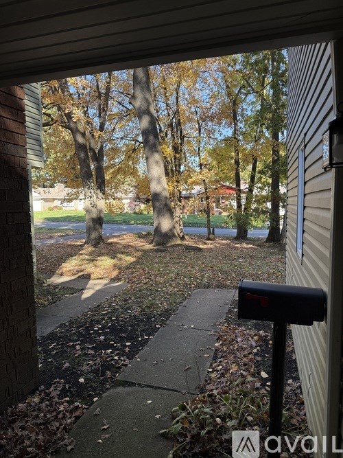 A mailbox is on the right side of a sidewalk.