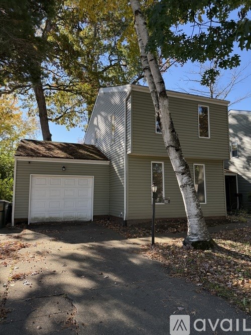 A house with a white garage door is for sale.
