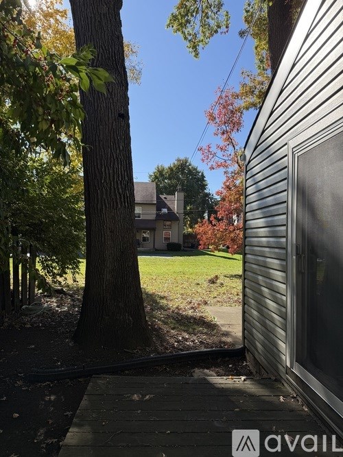A tree is in front of a house.