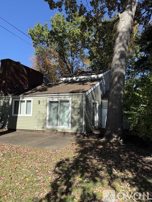 A house with a tree in front of it.