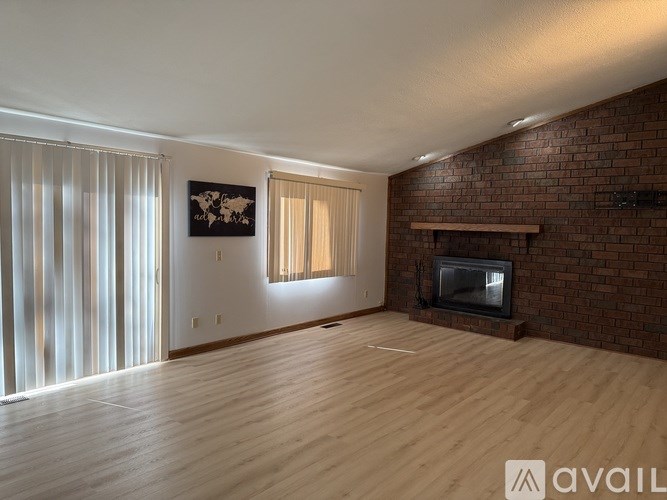 A room with a fireplace and a painting on the wall.