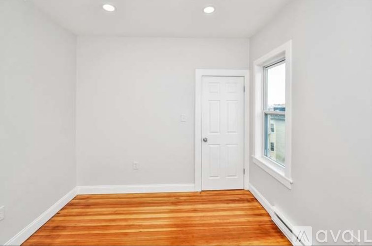 A room with a white door and a window.