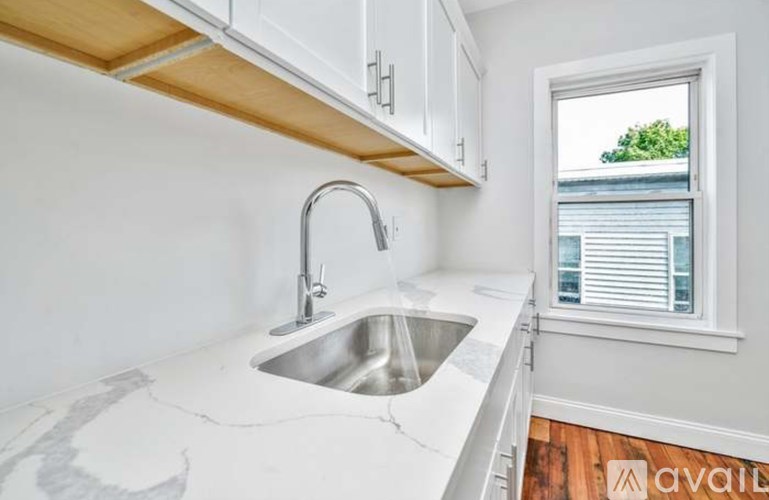 A kitchen with a sink and a window.