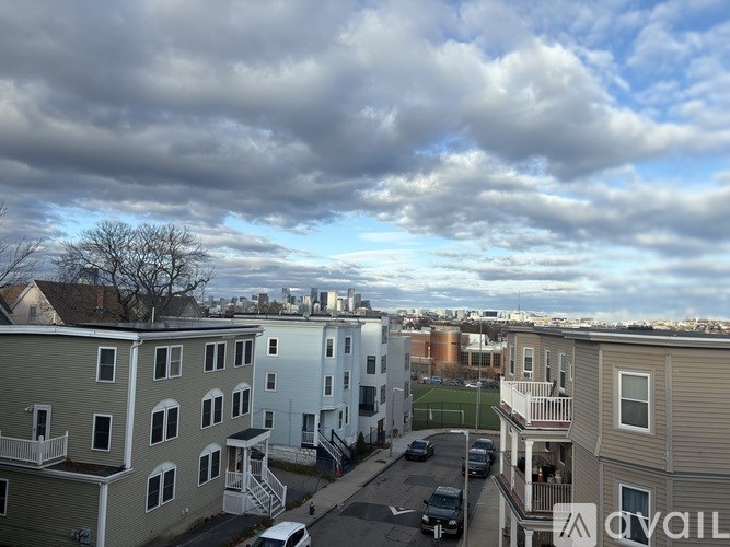 Apartment complex with a cloudy sky above.