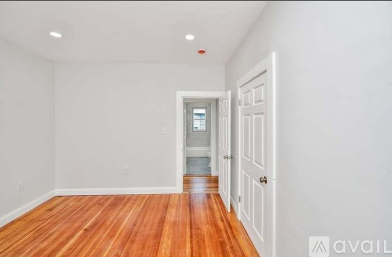 A room with wooden floors and white walls.