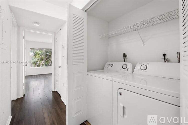 A white laundry room with a washer and dryer.