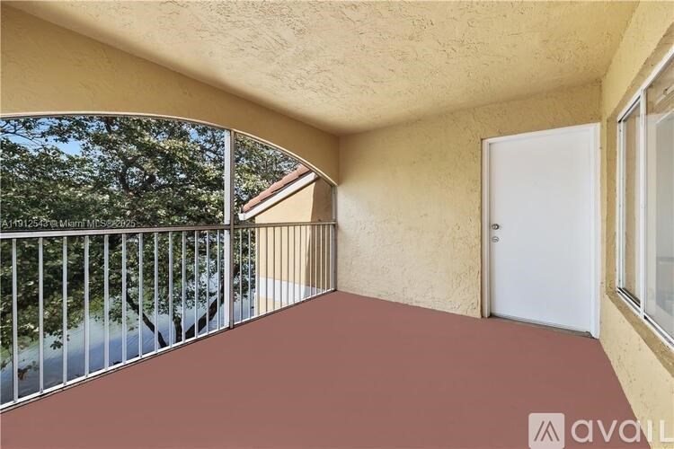 A balcony with a white door and a window.