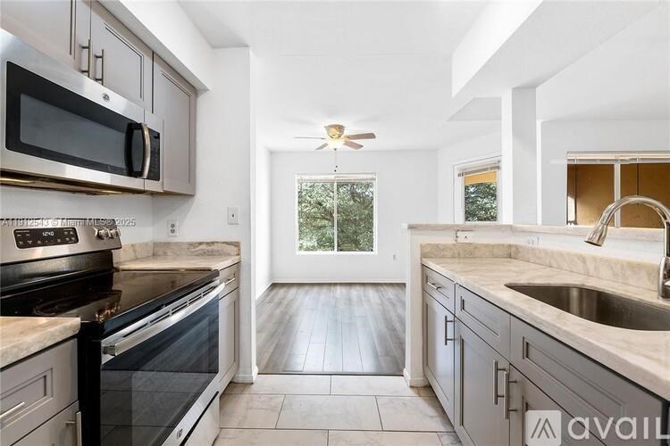 A kitchen with a black stove top oven and a black microwave.