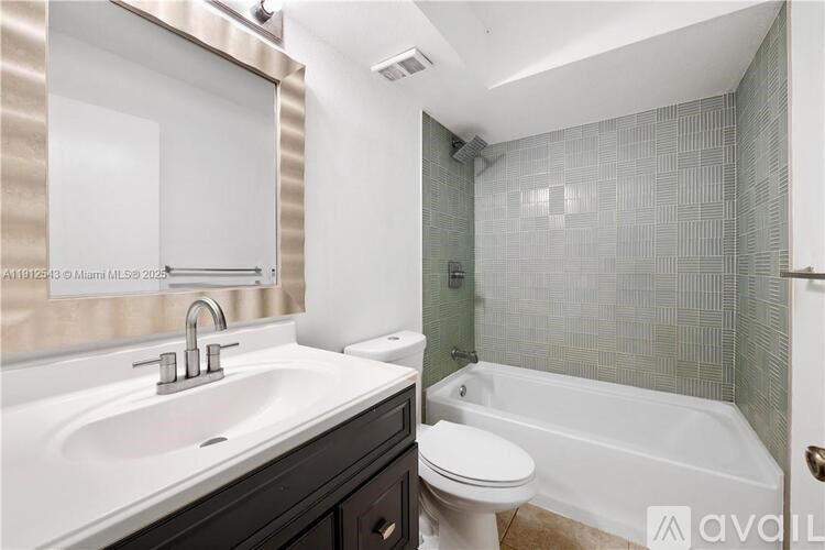 A bathroom with a white sink and a white toilet.