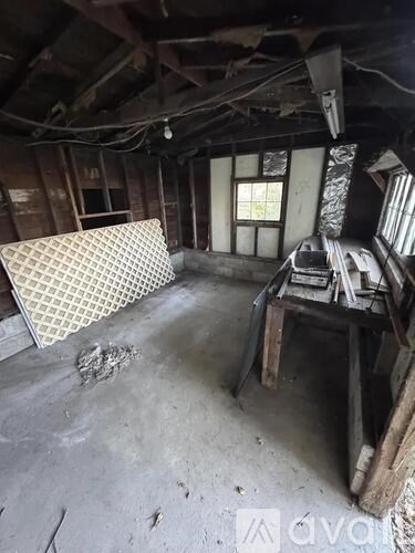 A room with a window and a table with chairs.