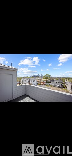 A balcony with a view of a residential area.