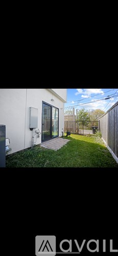 A modern house with a white exterior and a glass door.