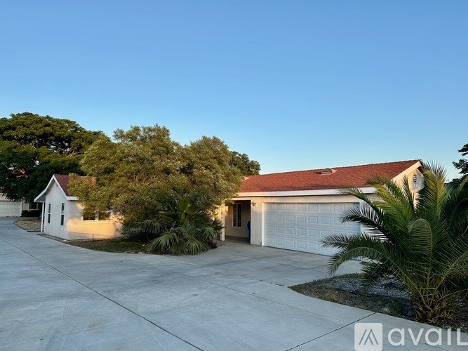 A house with a garage and a driveway is available for sale.