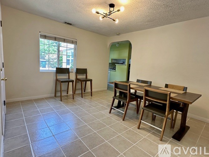 A dining room with a table and chairs.