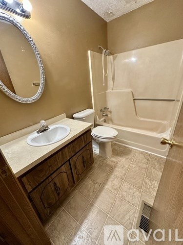 A bathroom with a sink, toilet, and bathtub.