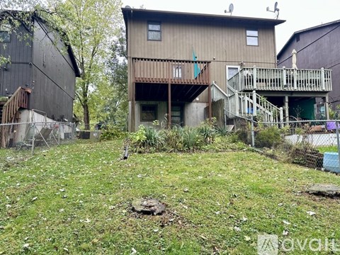 A brown house with a green flag on the front.