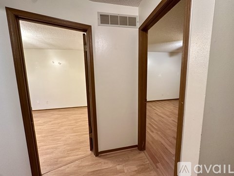 A room with a wooden floor and a white door.