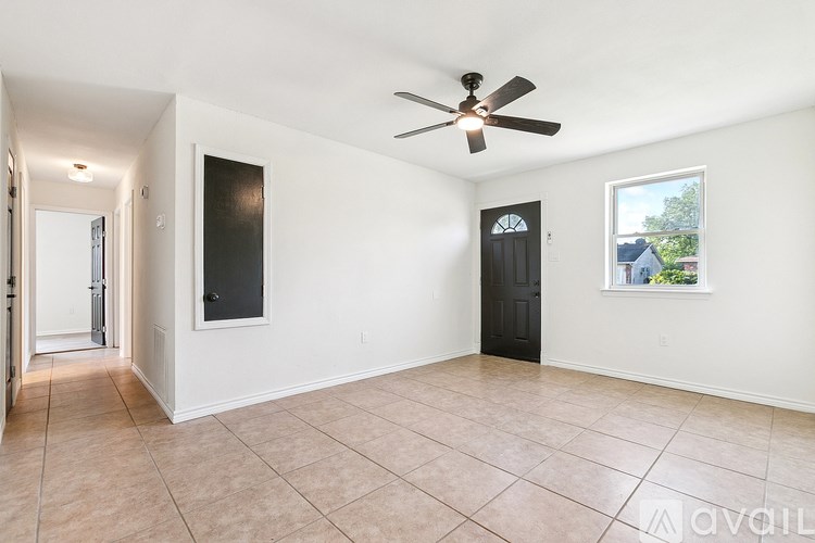 A room with a ceiling fan and a window.