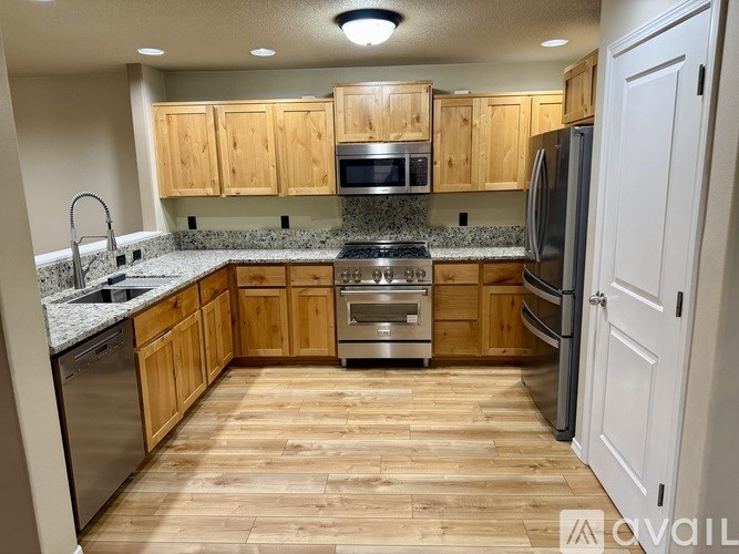 A kitchen with wooden cabinets and a white refrigerator.