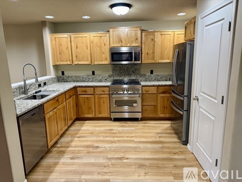 A kitchen with wooden cabinets and a white refrigerator.