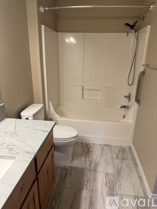A bathroom with a toilet, sink, and bathtub.