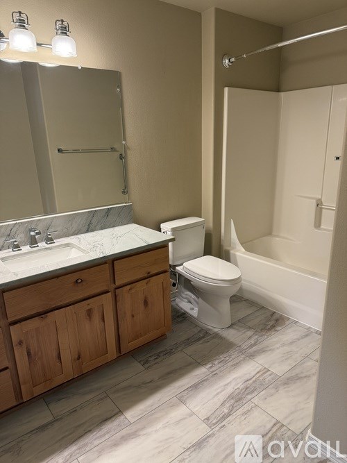 A bathroom with a toilet, sink, and bathtub.
