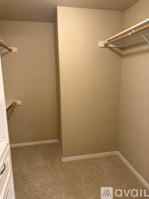 A small, empty room with a white cabinet and a shelf.