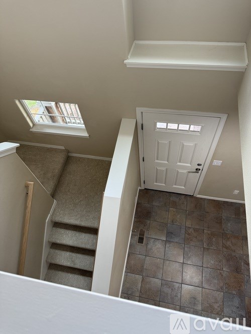 A small room with a staircase leading to the second floor.