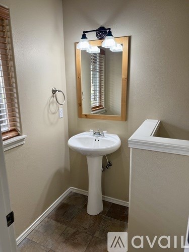 A bathroom with a sink and mirror.