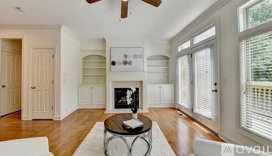 A living room with a fireplace and a coffee table.