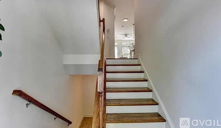 A staircase with wooden steps and a handrail.