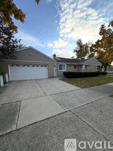 A house with a white garage door is for sale.