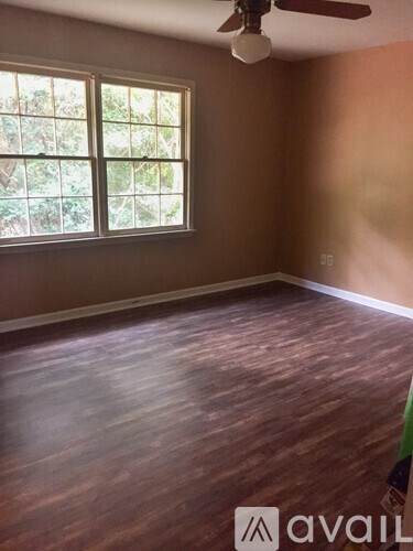 A room with a ceiling fan and a window.