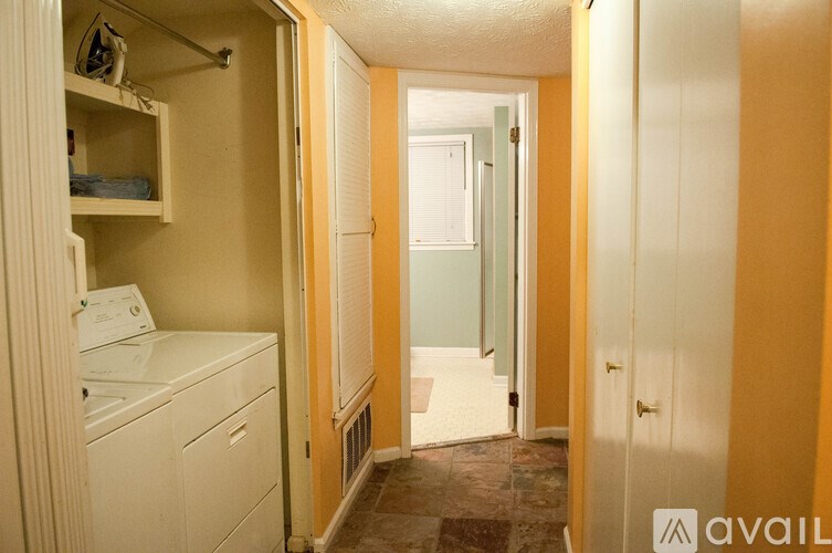 A small bathroom with a washer and dryer in it.