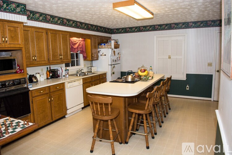 A kitchen with wooden cabinets and a white refrigerator.