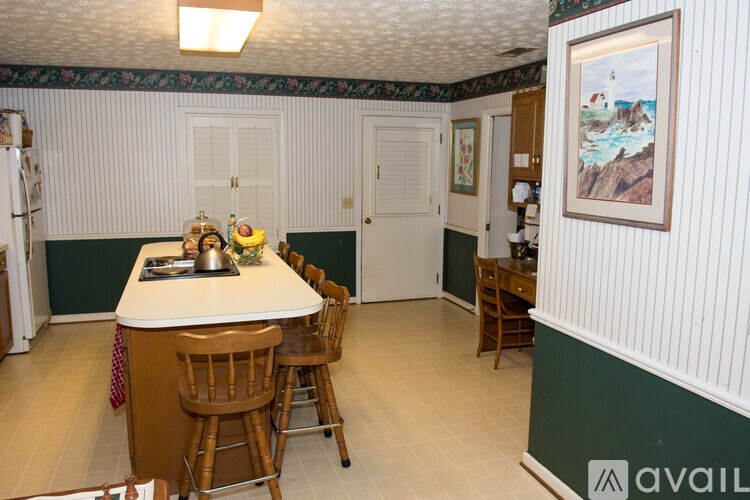 A dining room with a table and chairs.