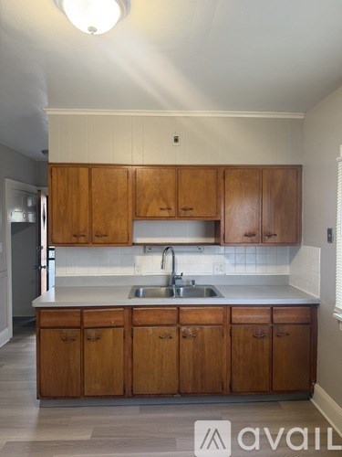 A kitchen with wooden cabinets and a white countertop.