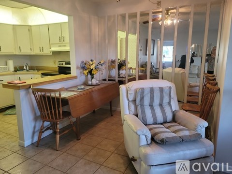 A kitchen with a dining table and chairs.