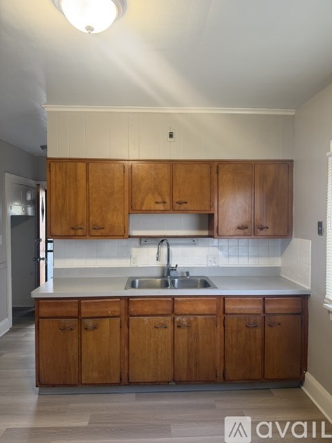 A kitchen with wooden cabinets and a white countertop.