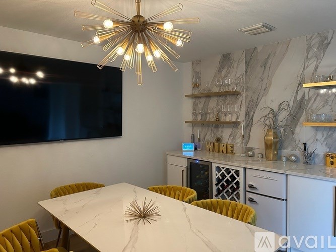 A modern dining room with a large table and yellow chairs.