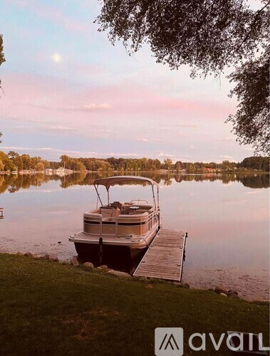 A boat is docked at a pier on a lake.